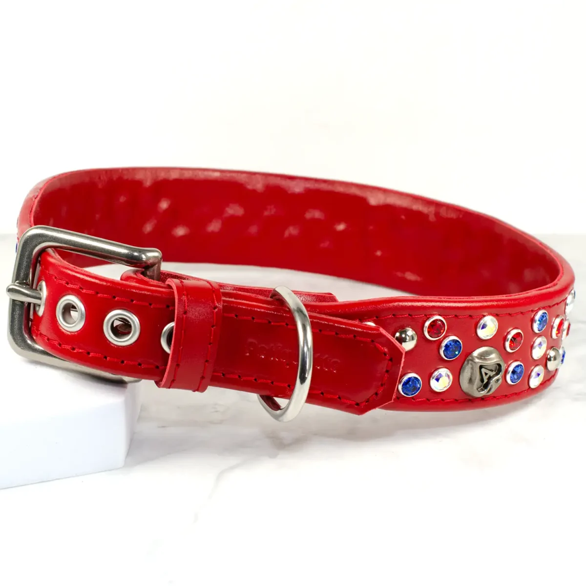 a red leather dog collar that is fitted with stainless steel hardware, and decorated with Swarovski crystals and playing card studs. Handmade by Petiquette