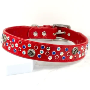 A wide, red leather dog collar covered in sparkling Swarovski crystals alongside Ace-of-Spades studs, handmade by Petiquette