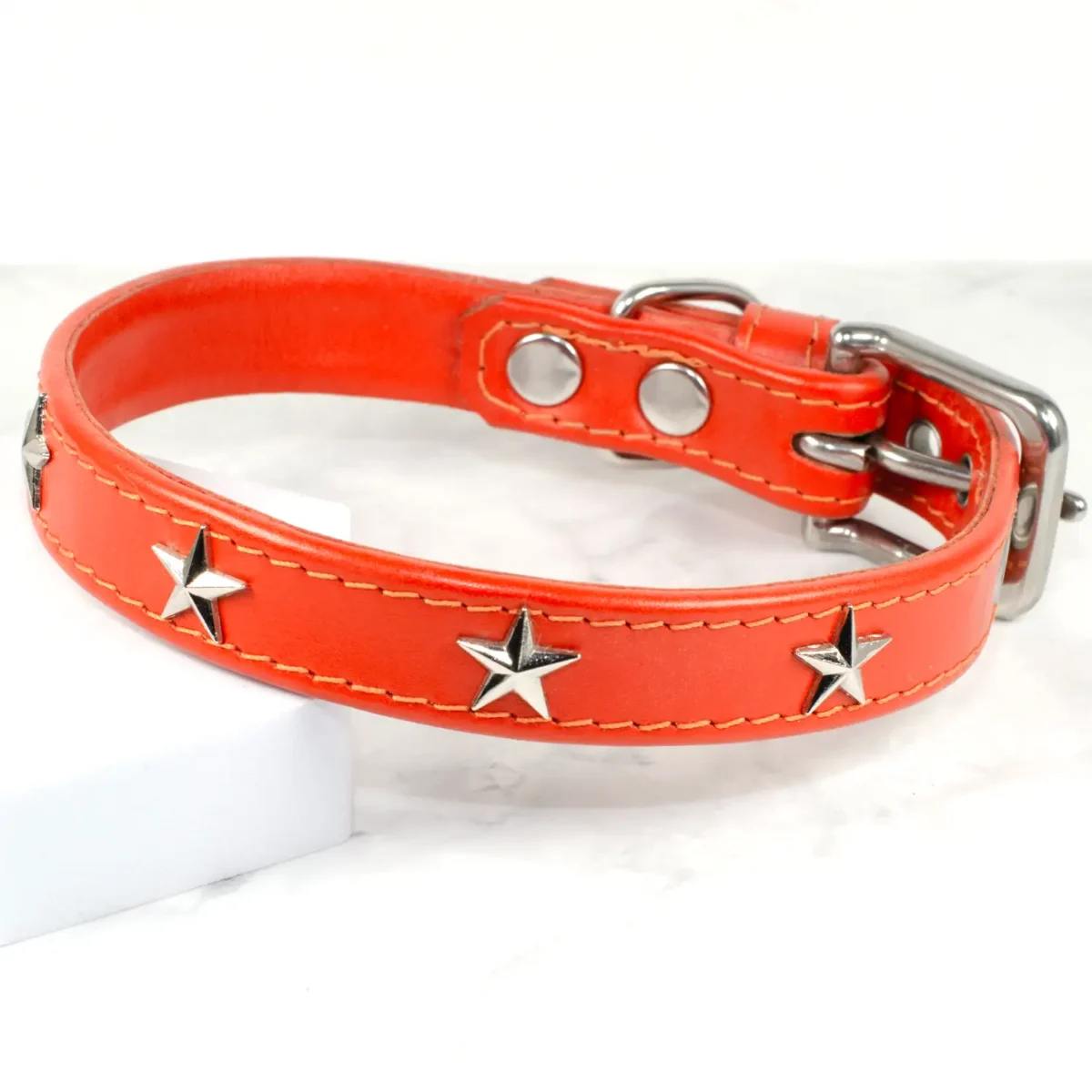 A jaffa orange leather collar for dogs studded with silver stars, handmade in the UK by Petiquette