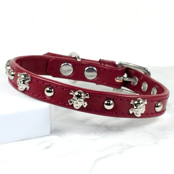 a burgundy leather dog collar with skull studs, handmade by Petiquette Collars