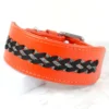 an orange leather whippet collar with a row of paracord braiding, handmade by Petiquette