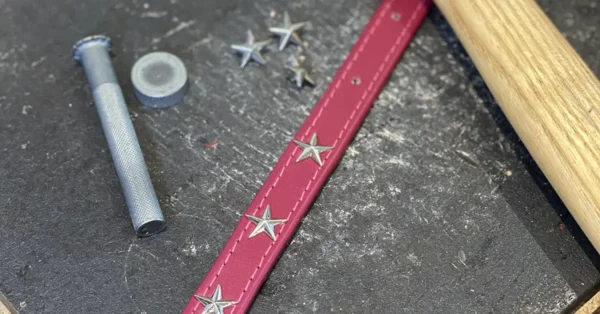 A star studded leather dog collar being made in a britisn workshop