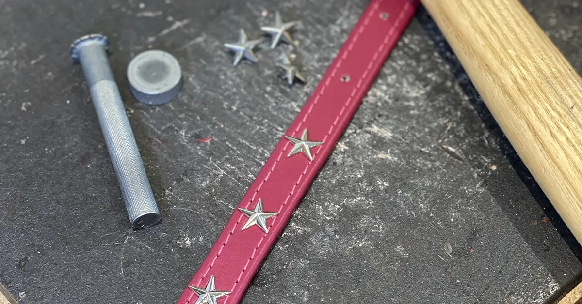 A star studded leather dog collar being made in a britisn workshop