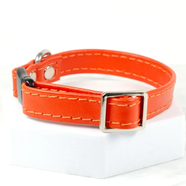 an adjustable orange leather puppy collar with safety clasp made by Petiquette