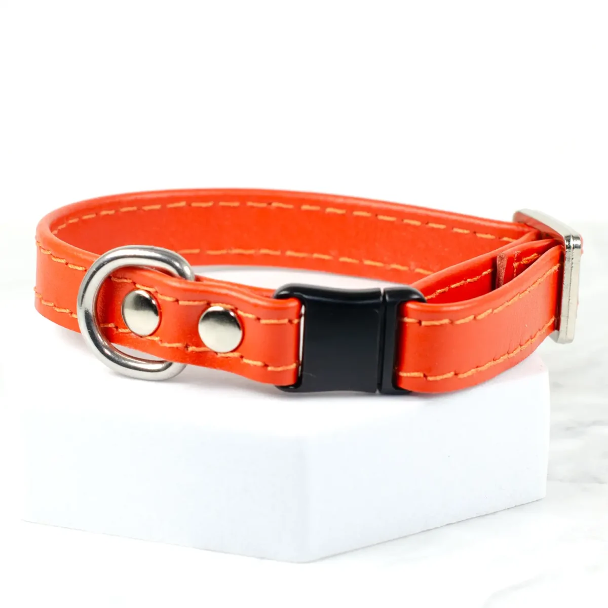 an orange leather cat collar made by Petiquette