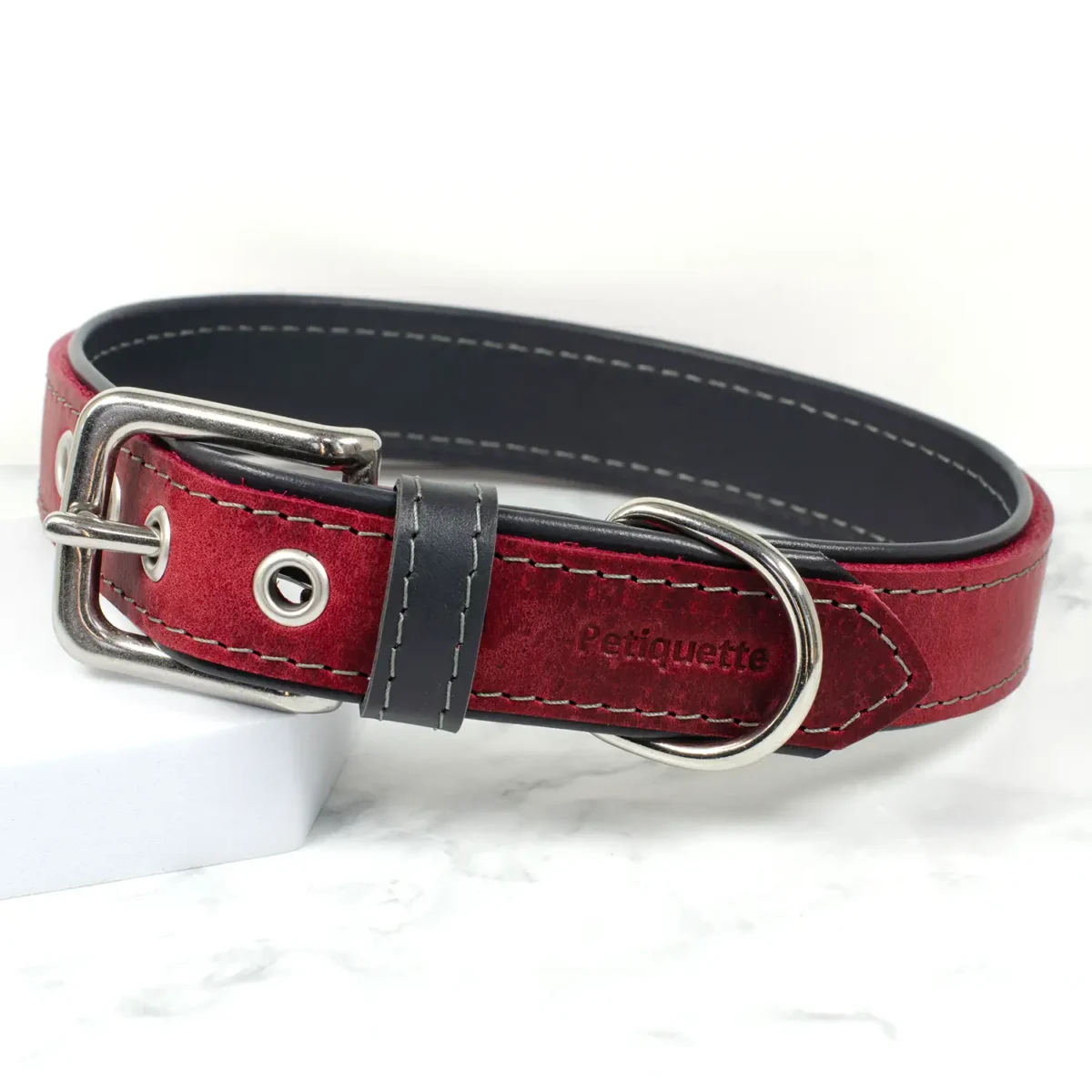 An oxblood and school grey coloured leather dog collar, handmade by Petiquette Collars