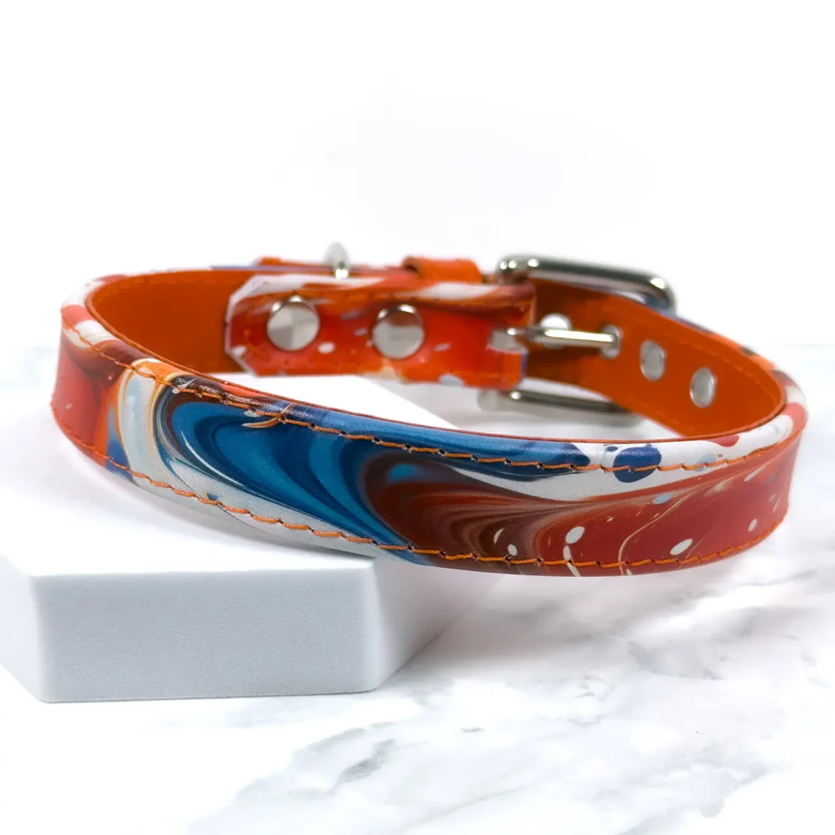 a leather dog collar with a paint spill like print, handmade by Petiquette