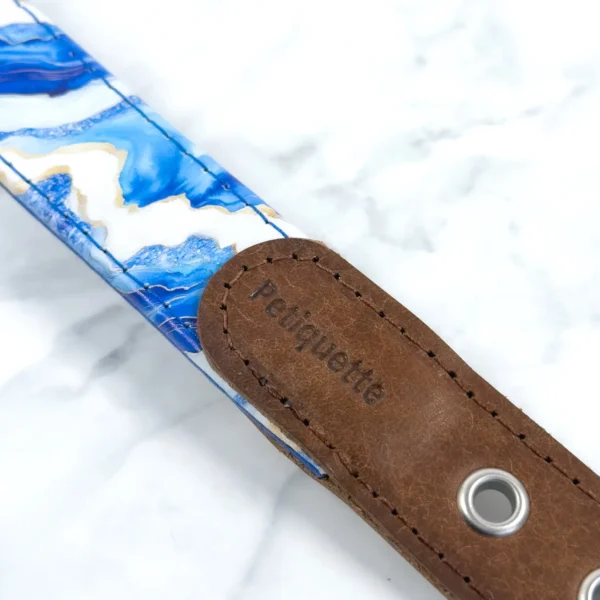 Retro Drops Printed Leather Dog Collar 6 Close-up of the Petiquette-stamped brown Italian leather buckle strap on the Blue Agate printed leather dog collar