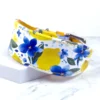 a wide leather sighthound collar with a watercolour print of lemons and flowers, handmade by Petiquette Collars